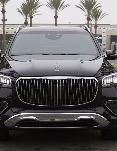 Front view of a black Mercedes-Maybach GLS SUV with chrome grille, photographed at Quality Coachworks for luxury or armored vehicle customization.
