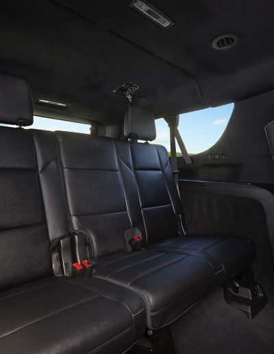 Second and third row seating layout inside a 6-door Gi SUV, customized by Quality Coachworks.