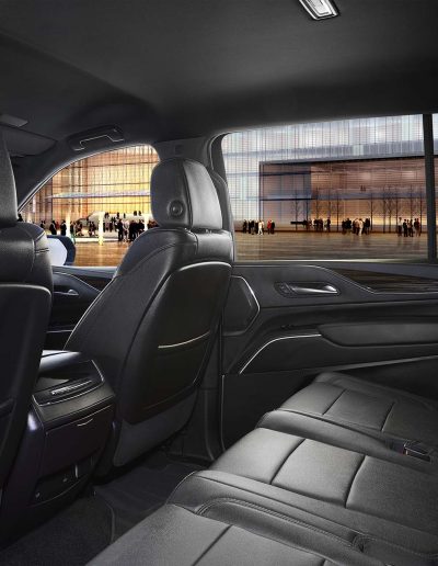 Interior rear cabin view of a black 6-door Yukon Denali SUV featuring leather seating and extended passenger rows.