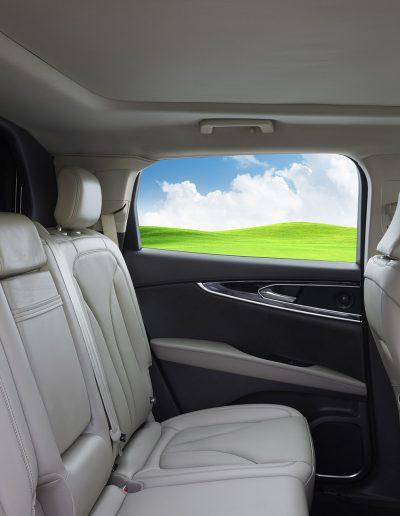 Passenger seating inside a Lincoln Nautilus 6-door hearse conversion with white leather upholstery and extended cabin space.