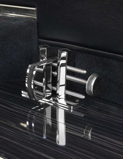 Close-up of custom chrome casket roller hardware inside a Lincoln Nautilus hearse conversion by Quality Coachworks